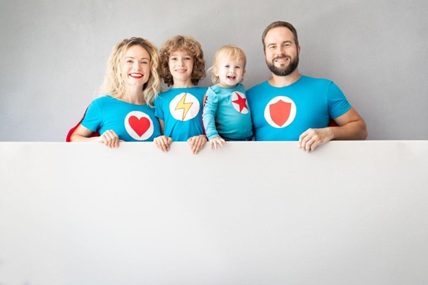 A family of four wearing custom-designed shirts with bold graphics and vibrant colors, symbolizing strength, unity, and heroism.